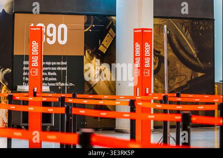 MALLORCA, SPAIN - APRIL 19, 2025: EasyJet bag drop area with branded queue barriers inside an airport terminal in Spain. Stock Photo
