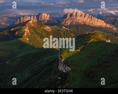 Scenic drone view of rocky mountains in the sunset light. Chertovy Vorota dolomite mountain at sunset Stock Photo