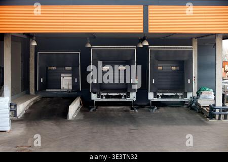 Loading dock or loading bay with bumpers, levelers, lift, dock seals or shelters, traffic lights. Loading bay is area of building where goods vehicles Stock Photo