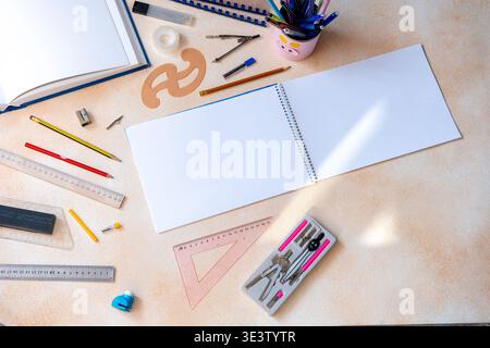 Blank spiral notebook with geometry drafting tools background. Various drawing instruments for school or engineering. Desk top view copy space Stock Photo