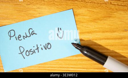 Sticky note or yellow note with the word "think positive" written on it Stock Photo