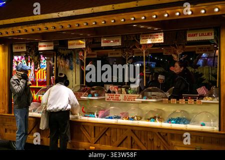 Cambridge Christmas Fair at Parkers Piece with festive candy stalls at night Stock Photo