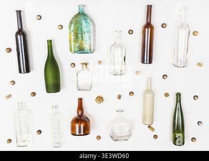 Lots of empty glass bottles and corks on white background Stock Photo