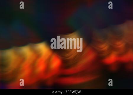An abstract background featuring a smooth blend of warm colors including red, orange, and yellow, with subtle waves creating a serene and harmonious t Stock Photo