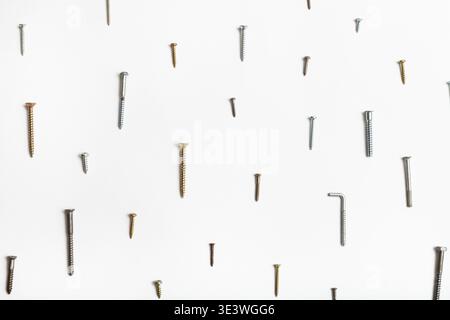 Wood screws and self-tapping screws arranged on white background Stock Photo