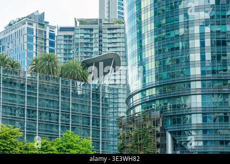 Modern glass office buildings with contemporary architecture and urban greenery in business district, Kuala Lumpur, Malaysia. Abstract architecture Stock Photo
