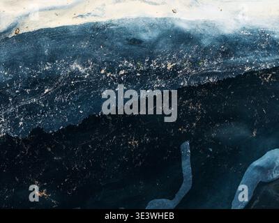 Abstract close-up of a natural landscape showcasing intricate patterns and textures. The interplay of dark and light hues creates a mesmerizing intima Stock Photo