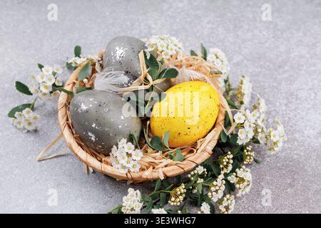Decorative easter eggs with yellow egg and white flowers Stock Photo