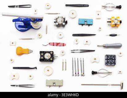 Watchmaker workshop ornament made from various watch repair tools on white background Stock Photo