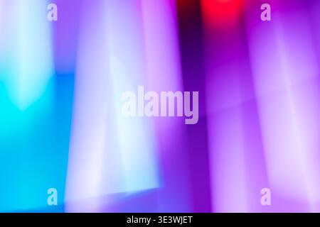 A vibrant abstract background displaying a blend of neon colors with a smooth gradient effect. The luminous hues of blue, purple, and pink create a dy Stock Photo