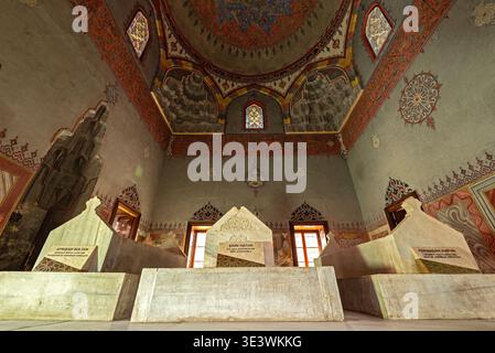 Interior view of royal tombs - March 24, 2022: Muradiye Complex, Bursa, Turkey - Low angle shot emphasizing the marble sarcophagi and decorated ceilin Stock Photo