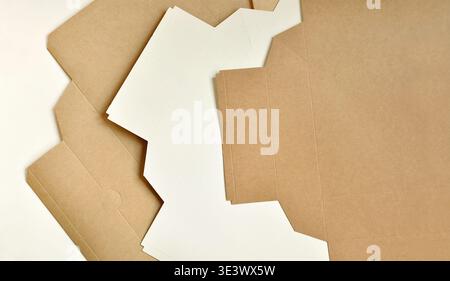 Cardboard brown boxes, unfolded, layered. Abstract artistic background. Sustainable packaging concept, packaging template, wood, paper industry Stock Photo