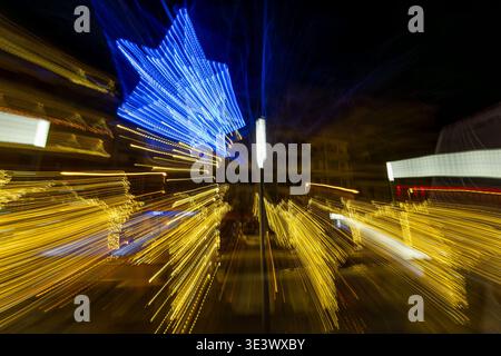 Abstract view of Christmas lights with dynamic motion blur creating a vibrant festive background. Stock Photo