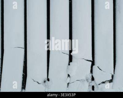Minimalistic Structure of Snow Covered Wooden Planks with Strong Black and White Contrast. Stock Photo