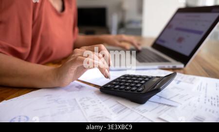 Close-up of female managing personal finances at home Stock Photo