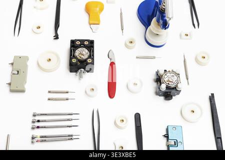 Watchmaker workshop collage of various tools for watch repair on white background Stock Photo