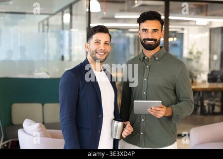 Portrait of smiling Middle Eastern coworkers posing in office Stock Photo