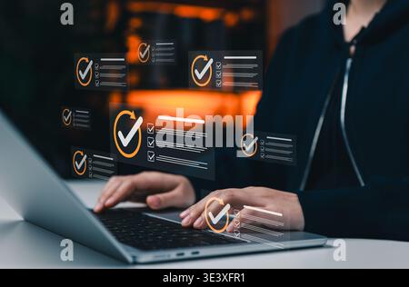 Digital task management and workflow control concept. Person using laptop with checklist for online verification, project tracking, process monitoring Stock Photo