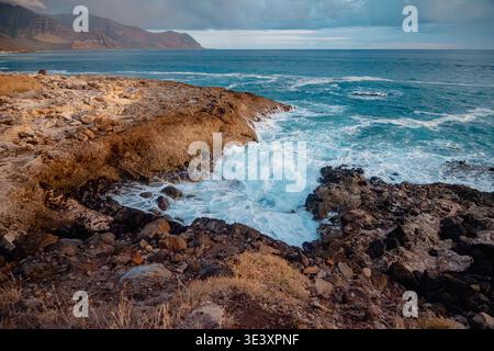 Vivid Ocean Sunset With Waves. Atmospheric Dusk Landscape Featuring Turbulent Sea And Stormy Sky Stock Photo
