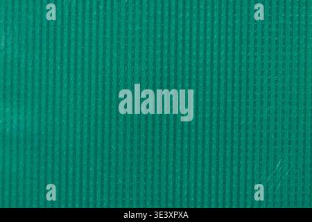 Close-up of a teal fabric with a ribbed texture, highlighting the vertical lines and smooth finish suitable for design projects Stock Photo