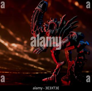 A curious toy alien figurine exploring its surroundings, capturing a playful science-fiction concept. Stock Photo
