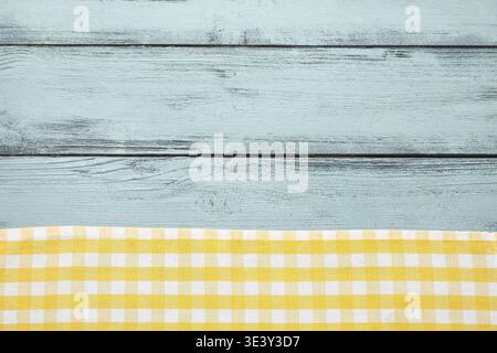 Checkered napkin on blue wooden background Stock Photo