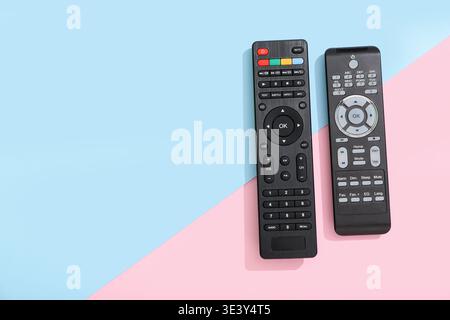 Different modern TV remote controls on color background Stock Photo