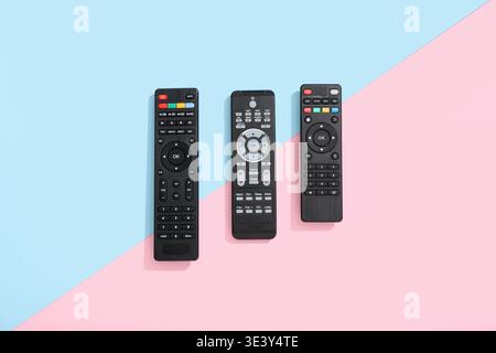 Different modern TV remote controls on color background Stock Photo