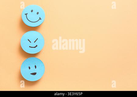 Sticky notes with smiley faces on orange background Stock Photo