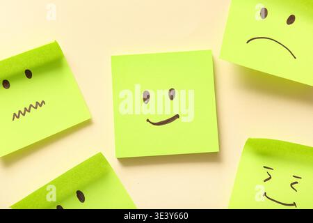 Sticky notes with drawings of different emotion faces on beige background Stock Photo