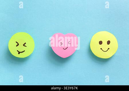 Sticky notes with smiley faces on blue background Stock Photo