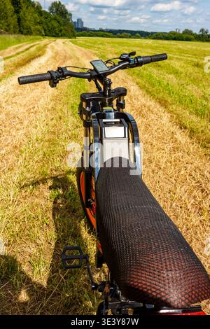 Ebike handlebars on dirt road, autumn ride into golden sunset, vibrant ...