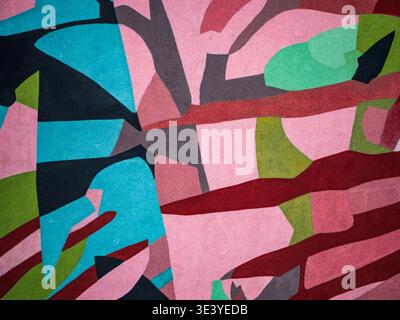 Vibrant abstract mural featuring geometric and organic shapes in bold pinks, blues, greens and reds, with visible textured paint strokes that evoke ur Stock Photo