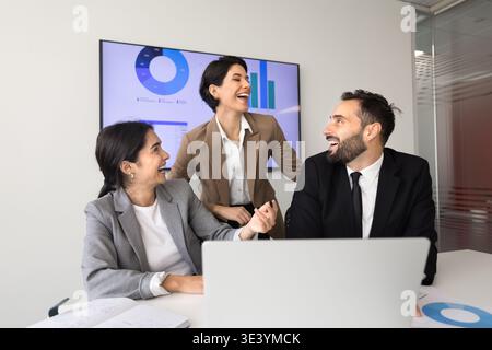 Laughing team collaborating during meeting in office Stock Photo