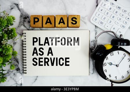 PaaS Platform as a Service text with calculator and alarm clock on marble background Stock Photo