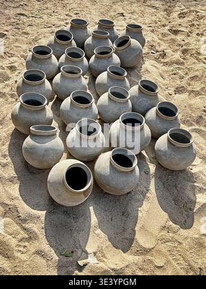 A collection of traditional clay pots to store water are waiting to be purchased at a potter's workshop near Jodhpur. Stock Photo