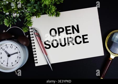 Open Source text with alarm clock and magnifying glass Stock Photo