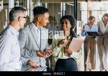 Team lead celebrating milestone with colleagues in office Stock Photo