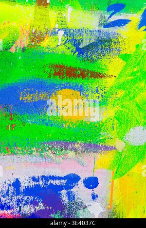 Lively abstract canvas with acrylic splatters and streaks in green, yellow, ideal for contemporary art backgrounds and creative design use. Stock Photo