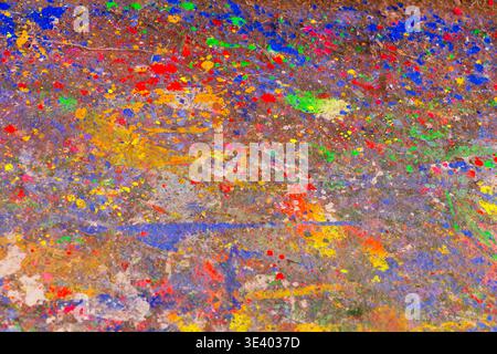 Weathered studio floor layered with paint drips in blue, green, red, yellow, pink, and orange at Zhen Yun Lin Ge Puppet Theater. Stock Photo