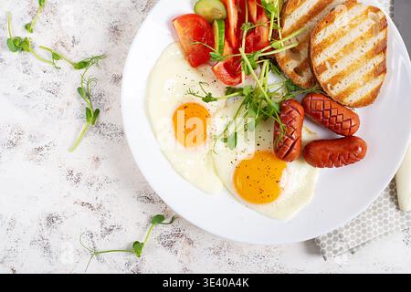 Hot Savory Breakfast with Sausage and Egg Closeup. Top view Stock Photo