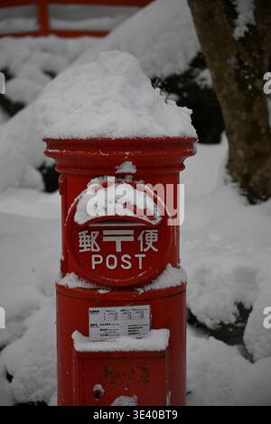 Red post box in the snow,Japan. Stock Photo