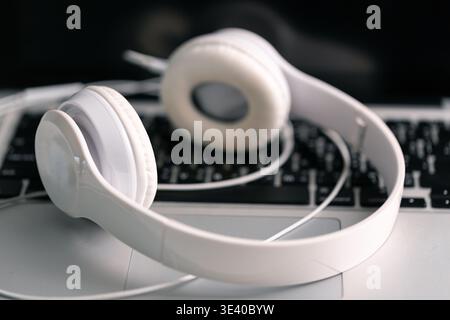 New technology modern Close up high resolution Wireless Earphones white Earbuds headphones black blur background Trendy minimal music device laptop co Stock Photo
