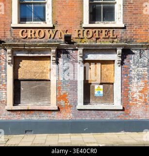 Historic Crown Hotel building boarded up frontage, High Street, Lowestoft, Suffolk, England, UK Stock Photo