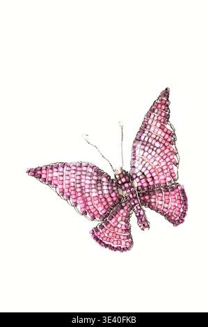 Butterfly brooch made from pink beads and twisted wire Stock Photo