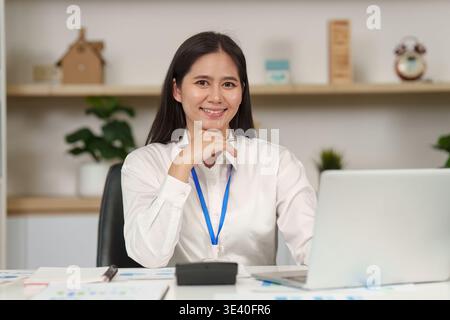 Professional accountant working at desk with laptop and documents Stock Photo