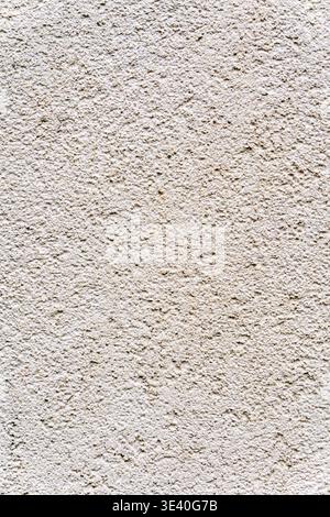 Close up of light beige wall with fine stucco texture and soft matte surface. Minimal abstract background with neutral tones and subtle grain. Stock Photo