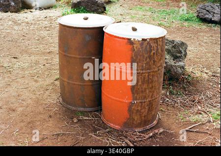 Rusty Metal Drums Outdoors on Dirt Ground Stock Photo