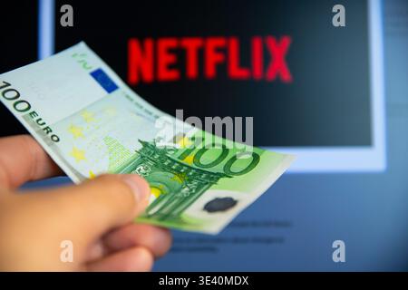 Belgrade, Serbia - February 24, 2026: 100 Euro bill in hand. Paying for Netflix. Netflix is a leading global subscription-based streaming service allo Stock Photo