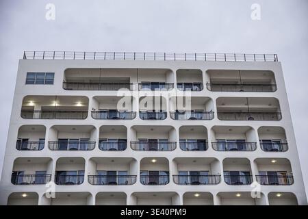 White Modern Apartment Building Facade with Repeating Balconies Stock Photo